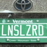 This backup camera cleaner hides behind your license plate