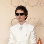 Timothée Chalamet Goes Full Y2K Boy Band in a White Suit and Goatee on the 2026 Oscars Red Carpet